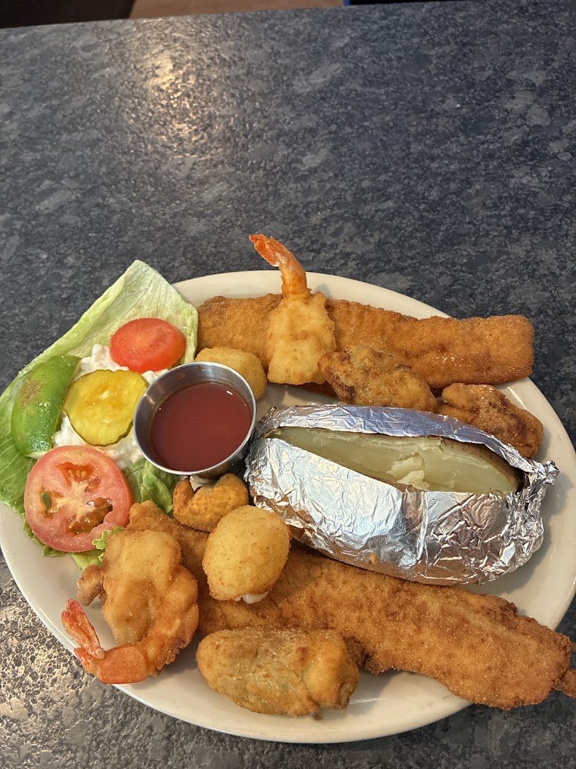 Plates of fried fish and oysters on display.